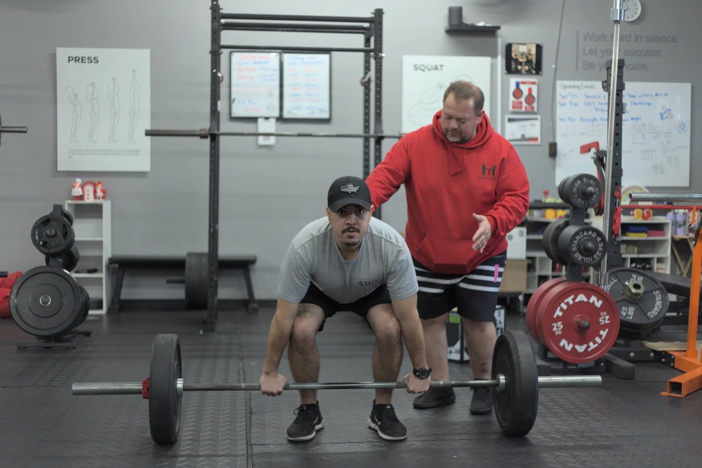 Our coach in a red hoodie on the floor at Halls of Strength