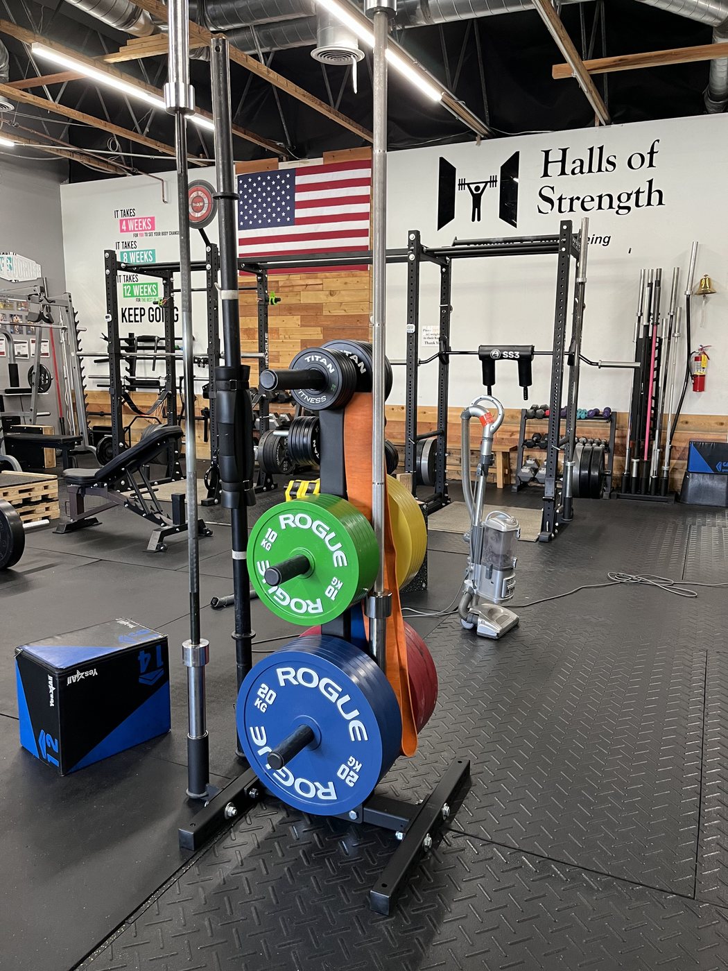 Plates racked under the Halls of Strength sign and the flag